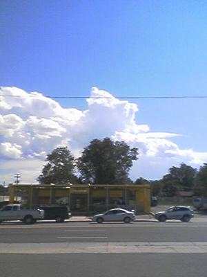 This is a recent photograph of some thunderheads behind a Mexican restaurant I used to go to all the time, called &quot;Taqueria de mi Pueblo&quot;. I was actually in the check cashing place across the street when I took this picture. 