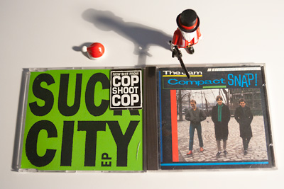 r: The Jam - Compact Snap
<br/><br/>
l: Cop Shoot Cop - Suck City 