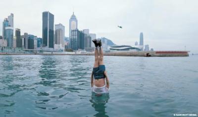 The amazing pictures of an artist dangling horizontally out of a skyscraper