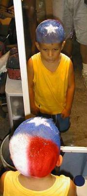 A Texas Flag painted on a young boy's head